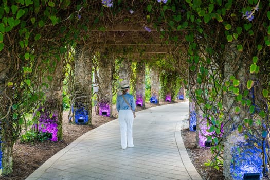 А woman walking in the covered alley in a park in Florida