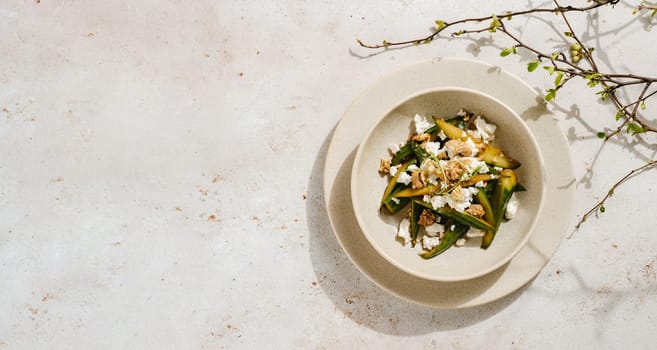 Asian Quick Pickled Cucumbers in Salad. Delicious salad with Asian style pickles cucumbers, goat cheese and walnuts nuts. Ideas and recipes for healthy breakfast, lunch or dinner. Top view or flat lay