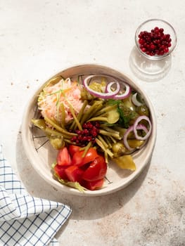 Assorted snacks from fermented cabbage, cucumbers and tomatoes, green bean. Decorated cranberry. Fermented healthy food concept. Pickled cucumbers, marinated tomatoes. Top view or flat lay. Vertical.