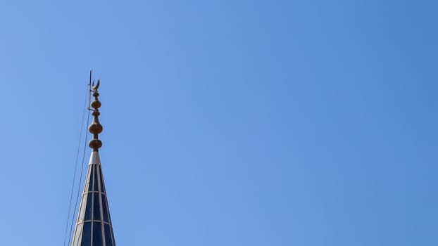 Mosque Minaret on a background of blue sky in Bitez, Bodrum, Turkiye