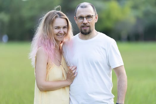 Romantic couple enjoying a leisurely day together in nature, embracing and smiling