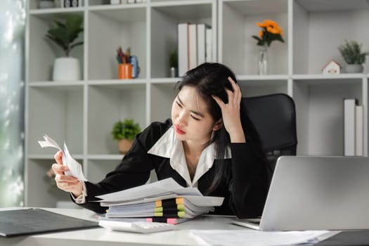 A focused accountant examines financial paperwork, showcasing the stress of tax season and the importance of accurate filing.