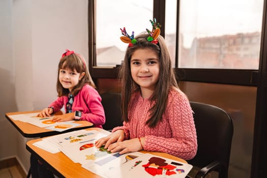 Two female elementary students together at language school.