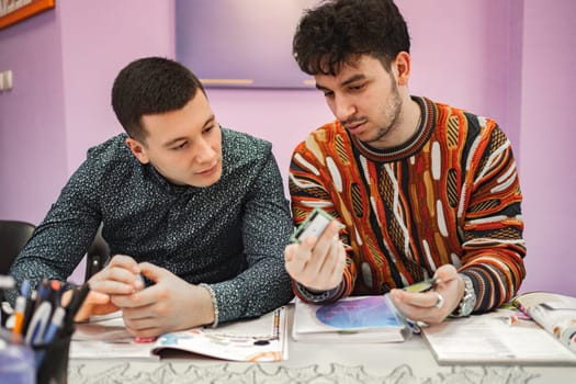 Two male students learning together at language school.
