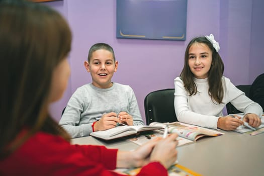 Group of elementary students learning together at language school.