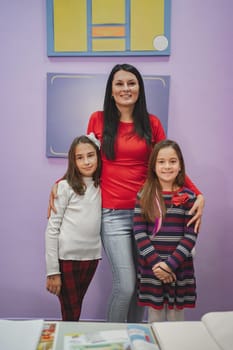 Female teacher with elementary students at language school class.