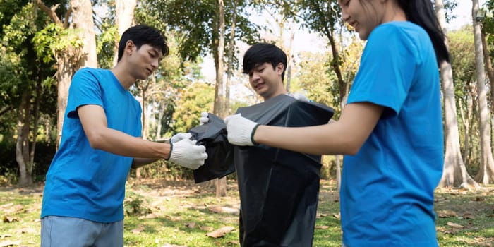 A team of young volunteers collaborates to collect waste, emphasizing teamwork and commitment to environmental conservation.