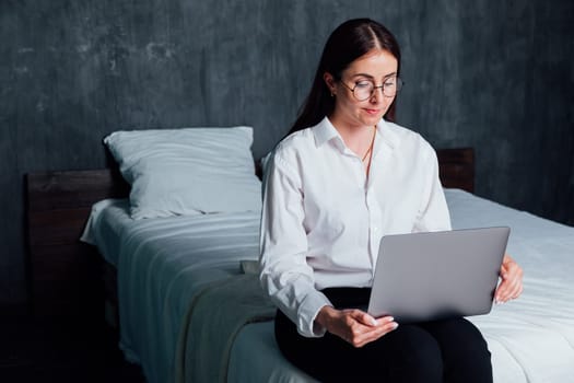 Woman working on laptop online at home