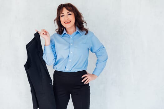Portrait of a beautiful woman in a gray blue suit