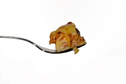 A savory bite of lasagna balanced on a fork reveals layers of cheese and meat, inviting an appetizing experience.