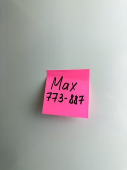 Max phone number. Written phone number on sticky note. Reminder on refrigerator on colored sticky note. Remember the desired phone number. 6 digit phone number and person name