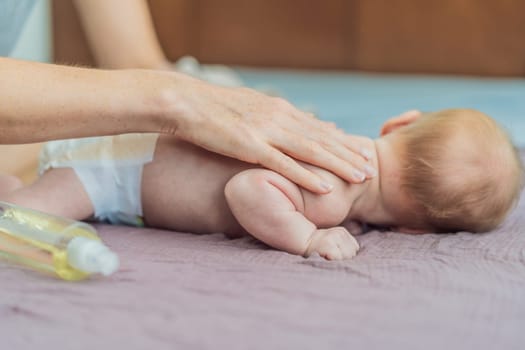 A mother gently massages her 1-month-old baby with baby oil after a bath. This tender moment highlights the bond between parent and child, promoting relaxation, baby care, and the importance of skin-to-skin contact.