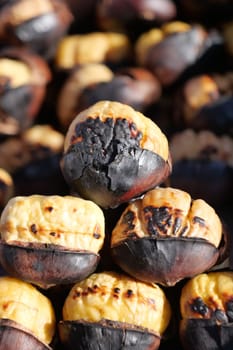 Delicious grilled chestnuts piled high at an outdoor market in autumn.