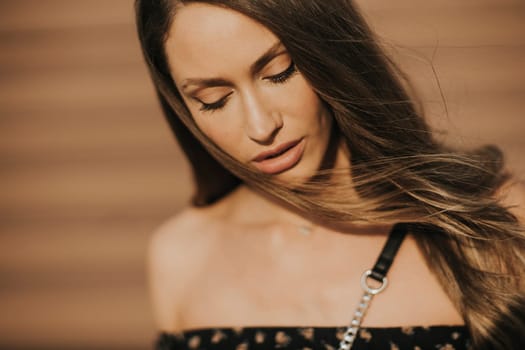 Outdoor portrait of sensual long hair brunette woman