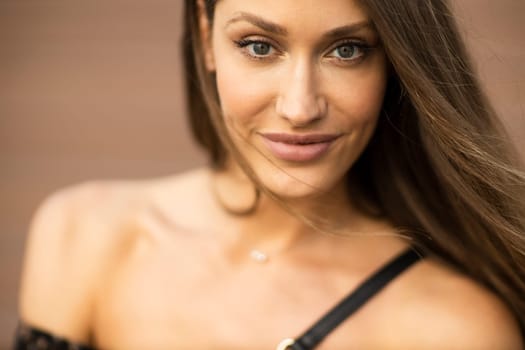Outdoor portrait of sensual long hair brunette woman