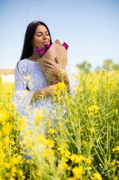Pretty young woman in the rapeseed field