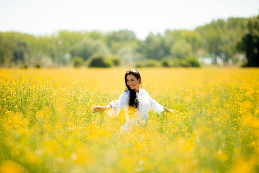 Pretty young woman in the rapeseed field