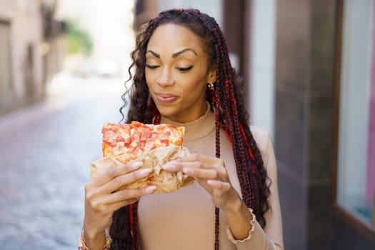 A joyfilled woman savoring a delicious slice of pizza in a charming and picturesque alley, radiating pure happiness and appreciation for the simple yet delightful experience of good food