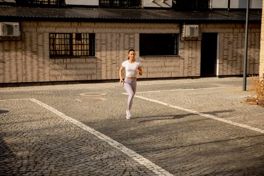 Pretty young woman running on the street