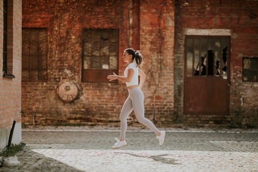 Pretty young woman running on the street