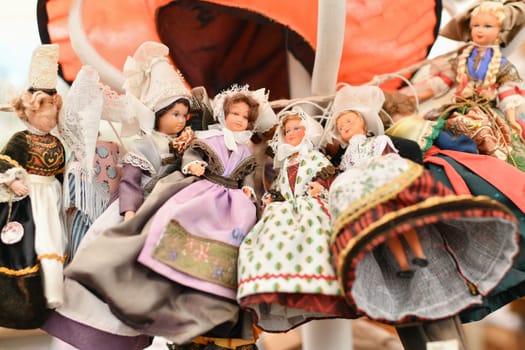 Lots of different Provencal, Breton vintage French dolls in national costumes at a flea market