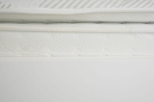 Soft mattress displays delicate patterns and textures in a bright room.