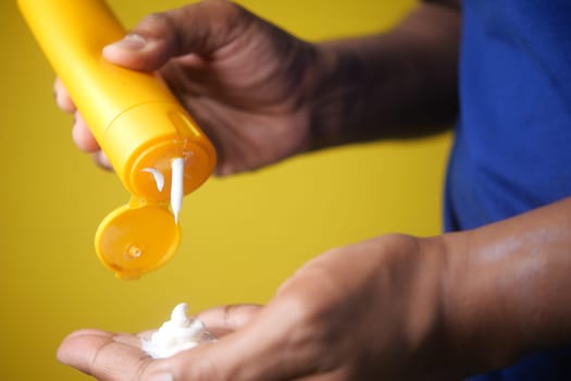 Close up of person hand using sunscreen cream ,