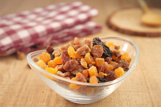 Colorful dried fruits are arranged in a bowl, enhancing the rustic setting.