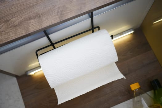 An overhead view of a paper towel holder in a modern kitchen space.