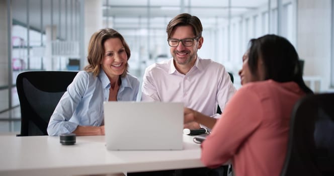 Happy couple meets with tax accountant and financial planner for advice.