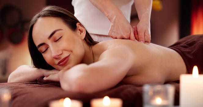 Relaxing shiatsu chiropractic back massage treatment by physio therapist at spa.