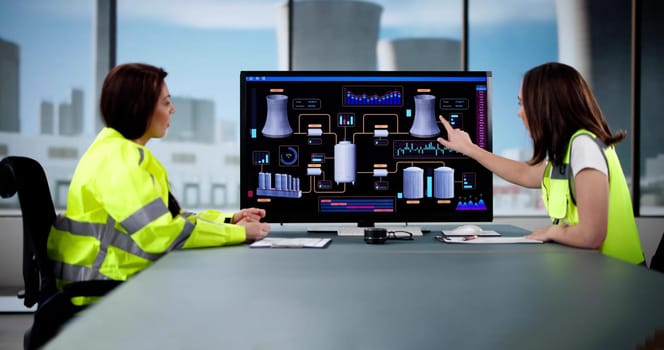 Woman Engineer Monitors SCADA System at Power Plant Control Panel.