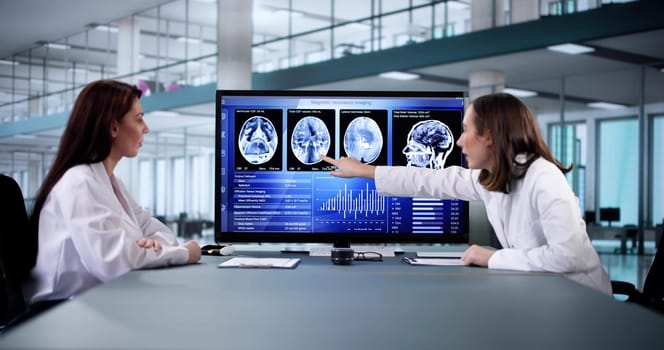 Female Neurologist Monitoring Brain Scan On Desktop Computer Screen