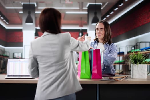 Woman At Hotel Talking To Receptionist In Business-Related Conversation vocation, marketing assistant, businesswoman, reception desk attendant, management trainee.