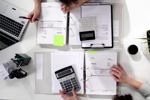 Female accountant working on tax audit in high angle view.