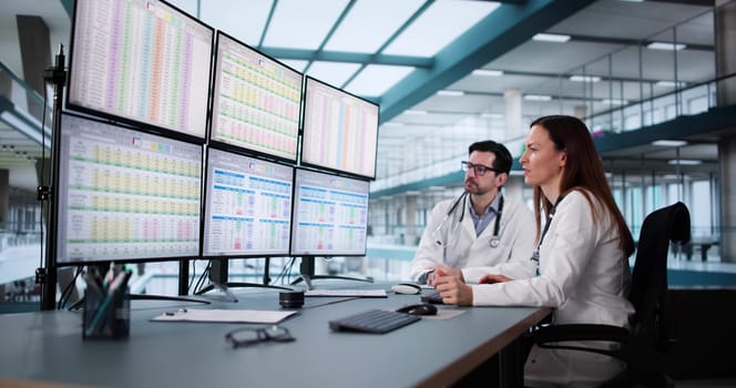 Medical Professional Managing Billing Codes Via Computer at Hospital Desk.