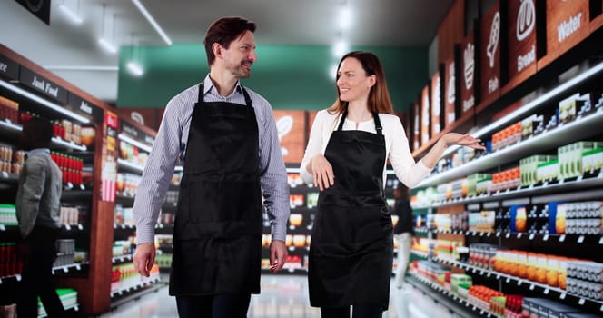 Teaching a Woman the Ropes at the Retail Supermarket Assistant.