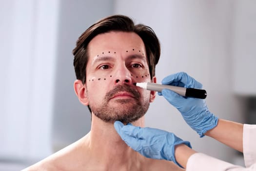 Male patient receiving cosmetic plastic surgery for facial aesthetics improvement.
