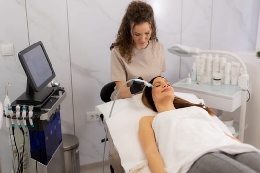 A skilled practitioner performs a revitalizing skincare treatment, focusing on pore cleansing and hydration for a relaxed client enjoying the healing ambiance of a wellness spa.
