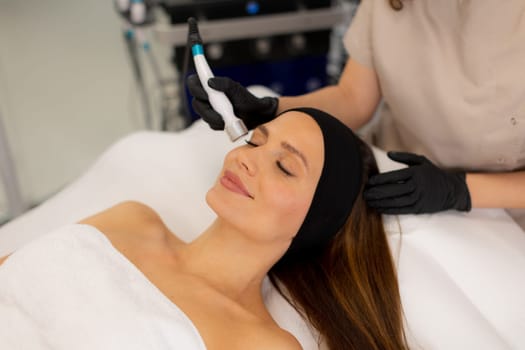 A skilled therapist performs a skin treatment that rejuvenates and hydrates while removing impurities, leaving the client refreshed and relaxed in a tranquil spa atmosphere.