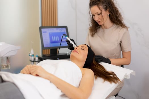 A skilled practitioner performs a revitalizing skincare treatment, focusing on pore cleansing and hydration for a relaxed client enjoying the healing ambiance of a wellness spa.