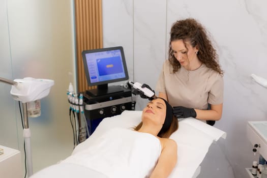 A serene setting showcases a skilled practitioner using an ultrasonic facial massager on a client's skin, promoting deep cleansing and relaxation for a radiant complexion.