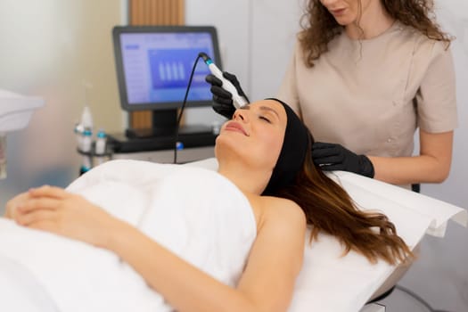 A skilled practitioner performs a revitalizing skincare treatment, focusing on pore cleansing and hydration for a relaxed client enjoying the healing ambiance of a wellness spa.