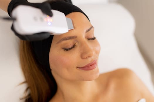 Soothing vibrations from the ultrasonic facial massager create a rejuvenating experience as the expert skincare professional cleanses and revitalizes the client’s radiant complexion.