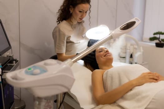 A tranquil spa setting features a woman enjoying a facial treatment, with mist enveloping her face. The atmosphere promotes relaxation and skincare rejuvenation.