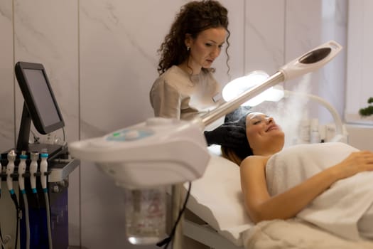 A tranquil spa setting features a woman enjoying a facial treatment, with mist enveloping her face. The atmosphere promotes relaxation and skincare rejuvenation.