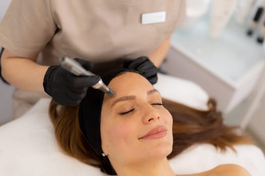 A skilled practitioner performs microneedling on a relaxed client, enhancing skin texture and rejuvenation. The tranquil spa ambiance promotes a sense of calm and well-being.