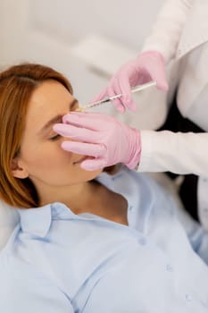 A client enjoys a dermal filler botox treatment in a modern clinic, as a skilled professional carefully administers the injections, fostering an atmosphere of relaxation and renewal.
