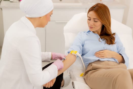 A healthcare provider gently draws blood from a patient seated comfortably in a modern medical office. The atmosphere is calm, ensuring a positive experience during the routine procedure.