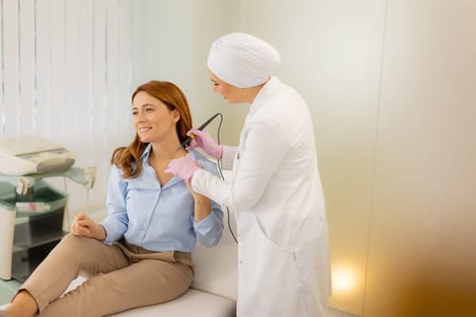 A skilled medical professional performs an electrocautery procedure on a smiling patient. The calm ambiance and attentive care highlight the importance of effective wart removal.